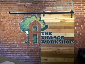 Custom signs in Livonia, installed farm-door style wooden sign on brick wall with custom painting