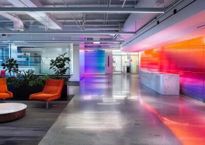 a vibrant office interior showcases a sleek branding installation, featuring bold graphics on modern walls, illuminated by dynamic led lighting that enhances the professional ambiance.