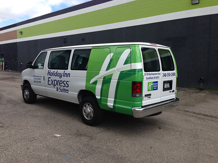A Holiday Inn Express van that has had van wraps installed in Southfield